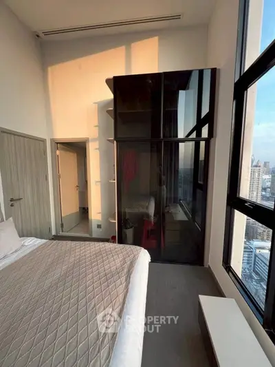 Modern bedroom with city view and sleek design in high-rise apartment
