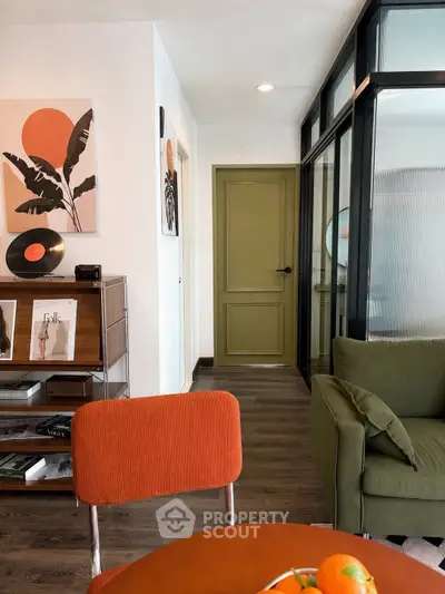 Stylish modern living room with vibrant decor and unique artwork, featuring a cozy seating area and sleek vinyl collection.