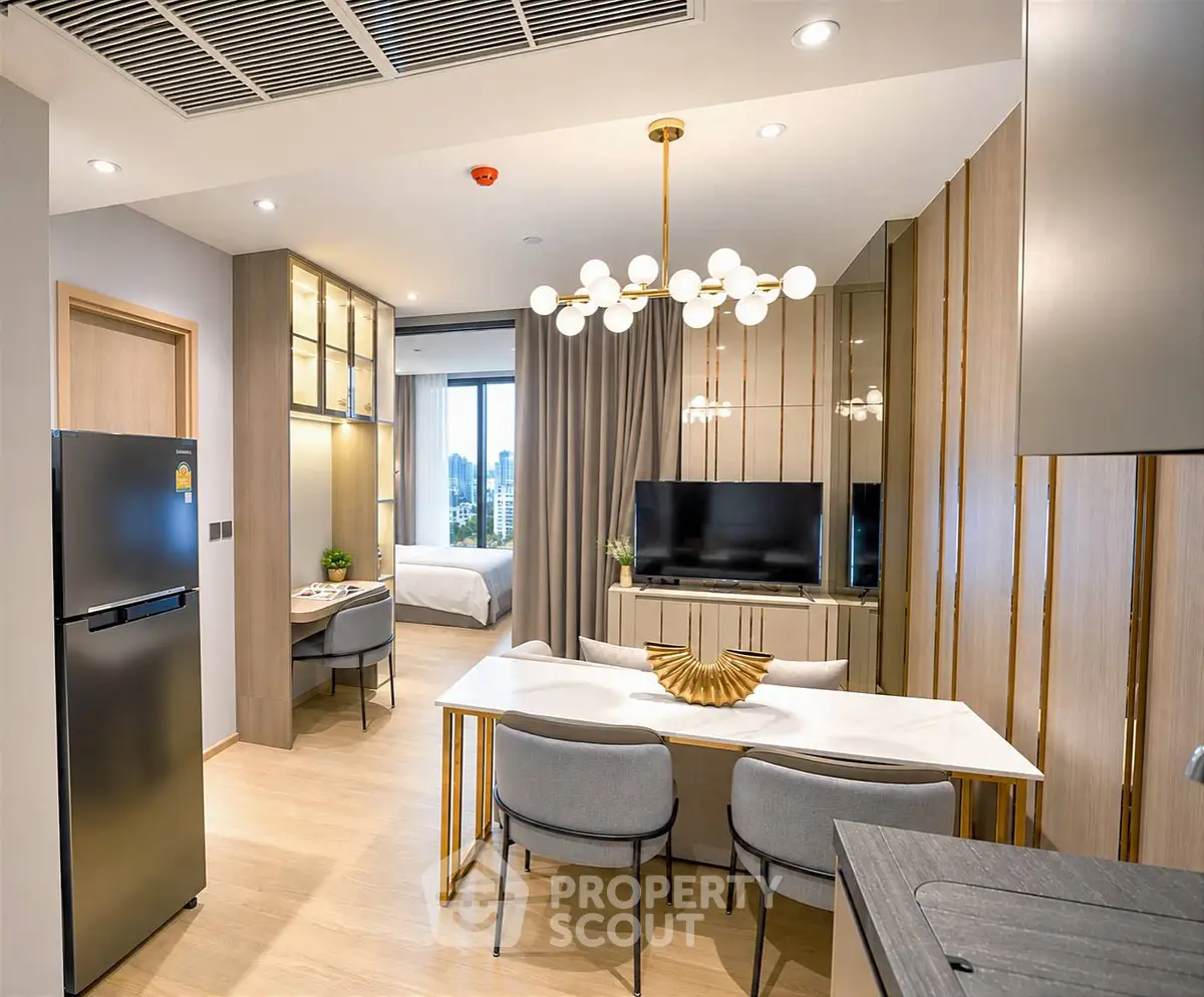 Modern open-plan living room with dining area and view of bedroom, featuring stylish decor and cityscape view.