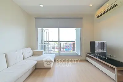 Modern living room with sleek furniture and balcony view