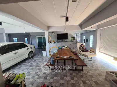Spacious open-plan living area with modern decor and indoor parking space
