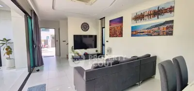 Spacious modern living room with stylish decor and large wall-mounted TV