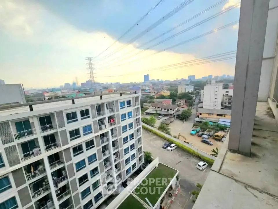 Stunning cityscape view from high-rise apartment balcony at sunset.