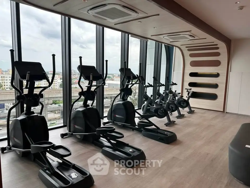 Modern gym with city view and state-of-the-art fitness equipment