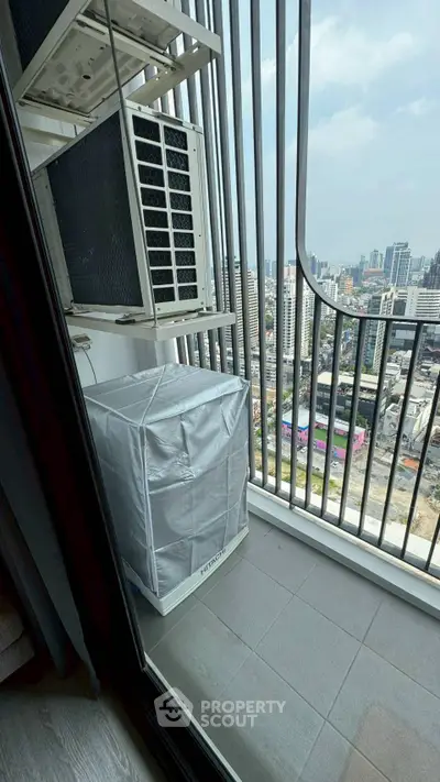Modern balcony with city view and air conditioning units, perfect for urban living.