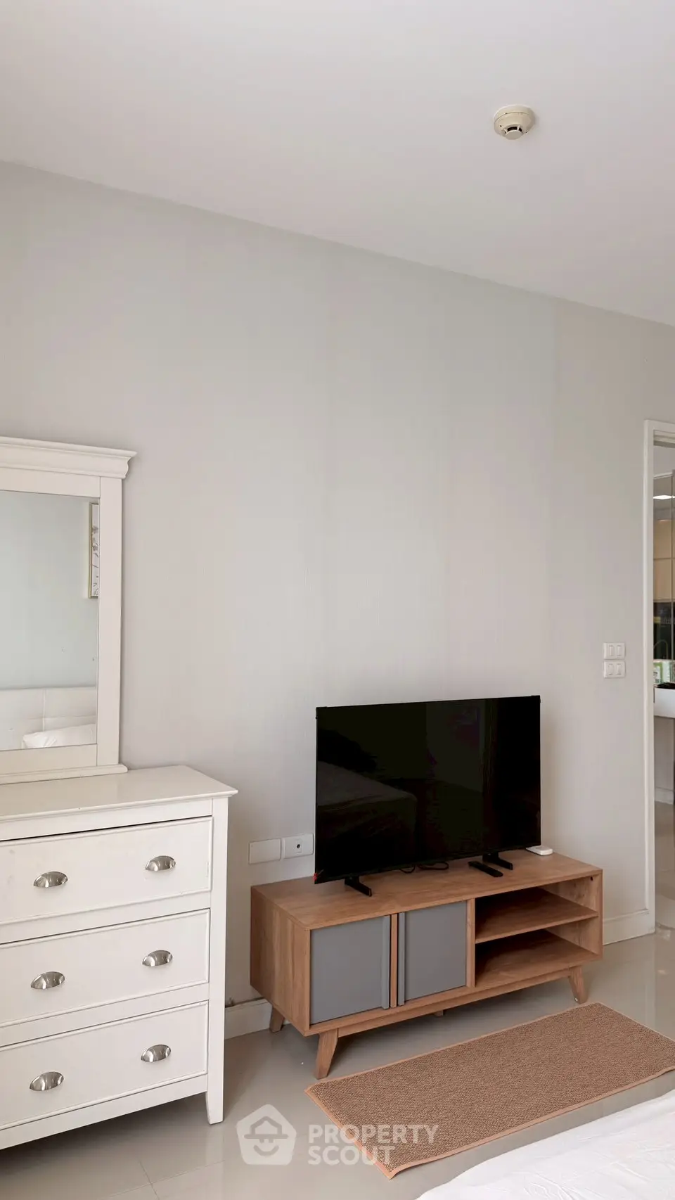Modern bedroom with sleek dresser and TV stand, ideal for stylish living.