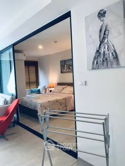 Stylish modern bedroom with elegant decor and large glass partition