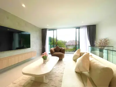 Luxurious living room with modern decor and large windows offering scenic views.