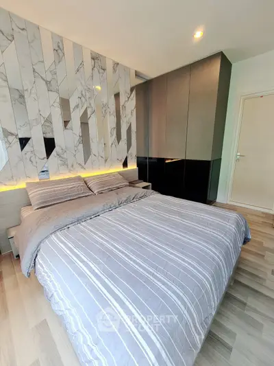 Modern bedroom with stylish decor and cozy ambiance in a contemporary apartment.