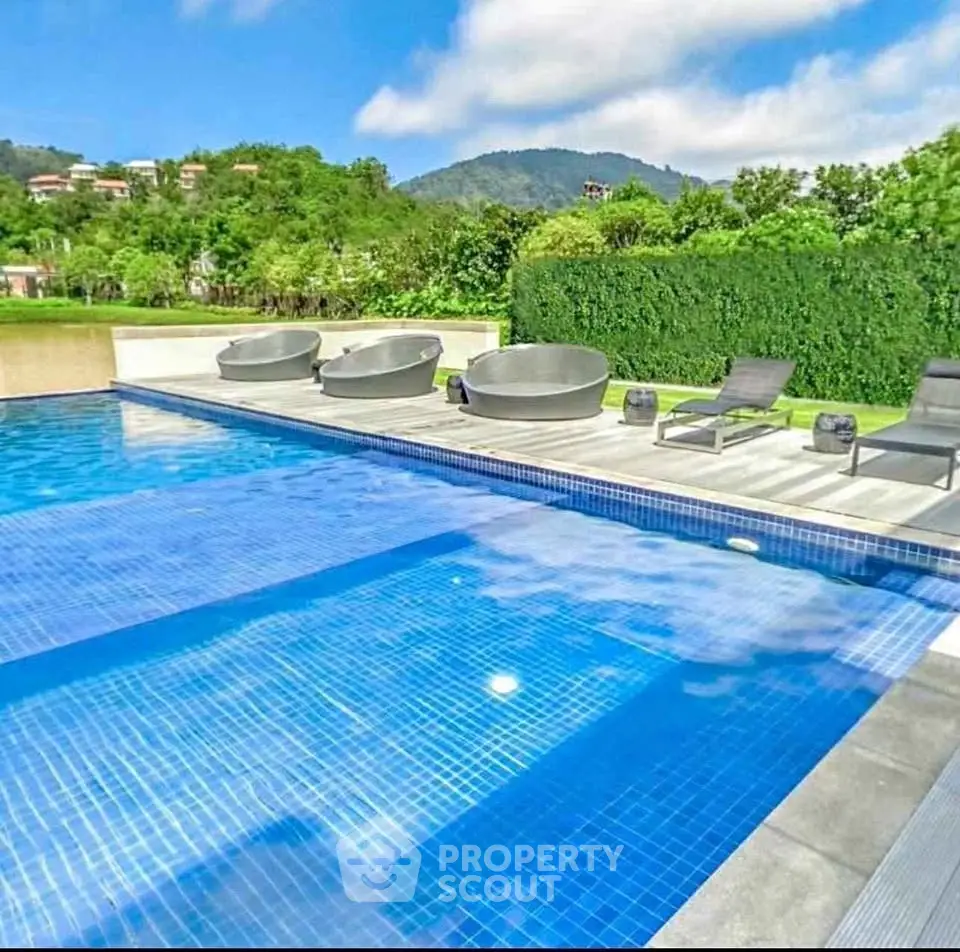 Luxurious outdoor pool with scenic mountain views and modern seating area.