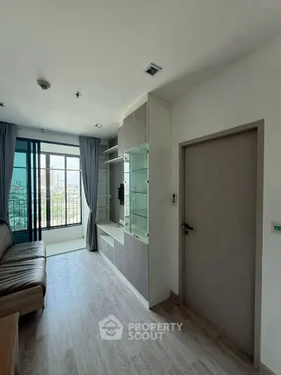 Modern living room with large windows and sleek furniture, offering a bright and airy atmosphere.