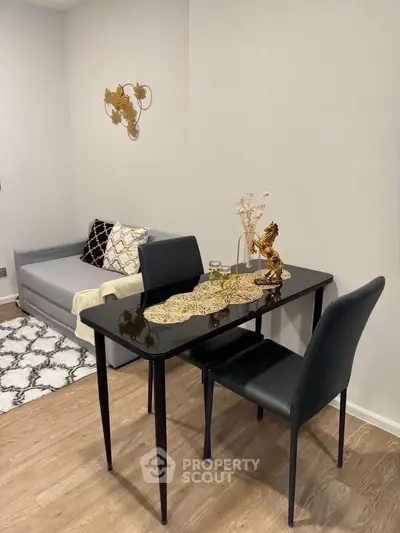 Stylish modern living room with sleek dining table and cozy sofa, perfect for urban living.