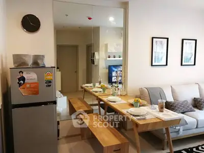 Modern living room with dining area and stylish decor in a cozy apartment setting.