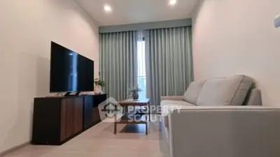 Modern living room with sleek furniture and large TV, perfect for relaxation.