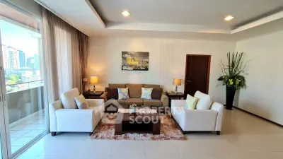 Spacious living room with modern decor and large windows offering city views.