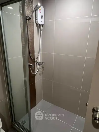 Modern bathroom with sleek shower enclosure and electric water heater