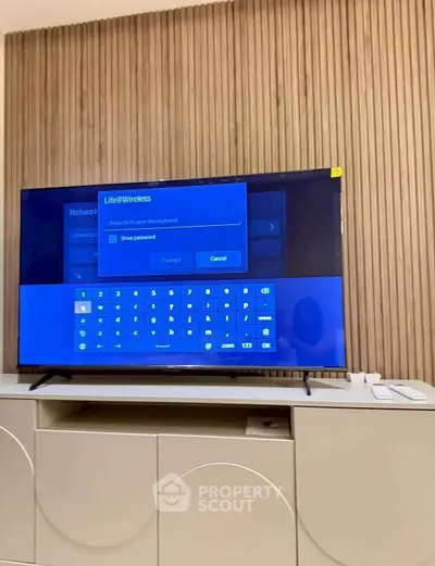 Modern living room with sleek TV and stylish wooden panel wall