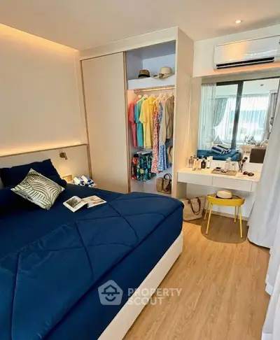Modern bedroom with stylish decor and balcony view, featuring a cozy bed and open closet.
