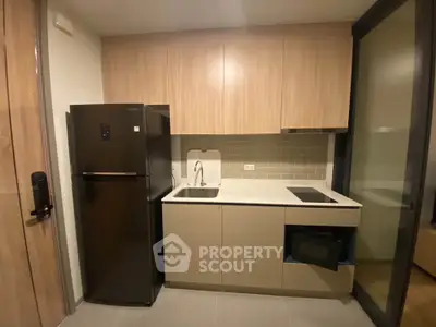 Modern compact kitchen with sleek cabinetry and appliances