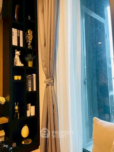 Stylish living room corner with elegant shelving and large window view.