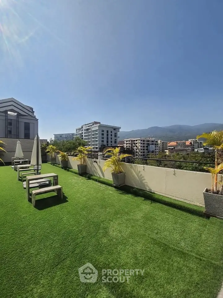 Stunning rooftop garden with panoramic city and mountain views, perfect for relaxation and entertainment.