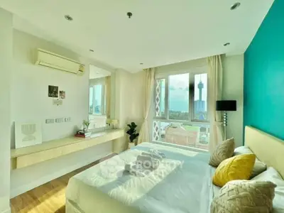 Bright and airy bedroom with city view, modern decor, and natural light.