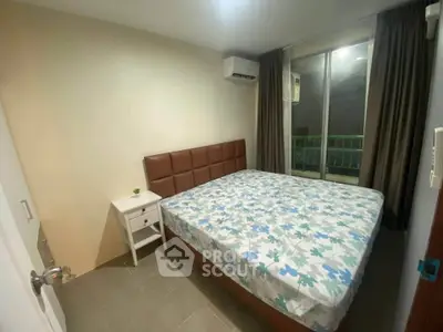 Cozy bedroom with large bed and balcony access in modern apartment