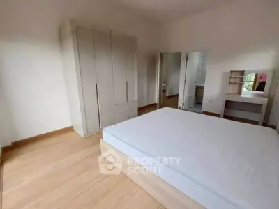 Spacious bedroom with modern wardrobe and natural light