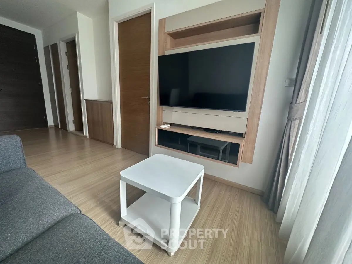 Modern living room with sleek TV setup and minimalist furniture