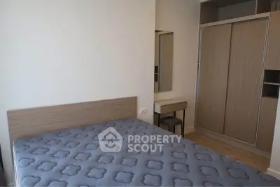 Modern bedroom with wooden wardrobe and stylish bed in a cozy apartment.