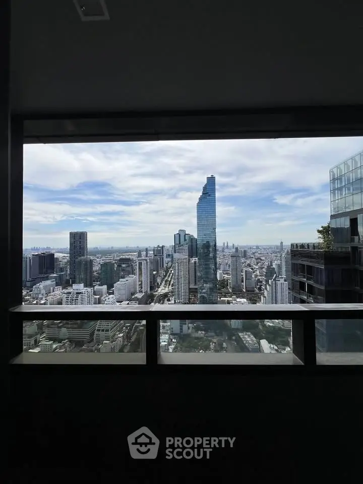 Stunning cityscape view from a high-rise balcony, showcasing modern skyscrapers and expansive skyline.