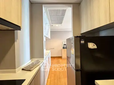 Modern kitchen with sleek appliances and wooden flooring