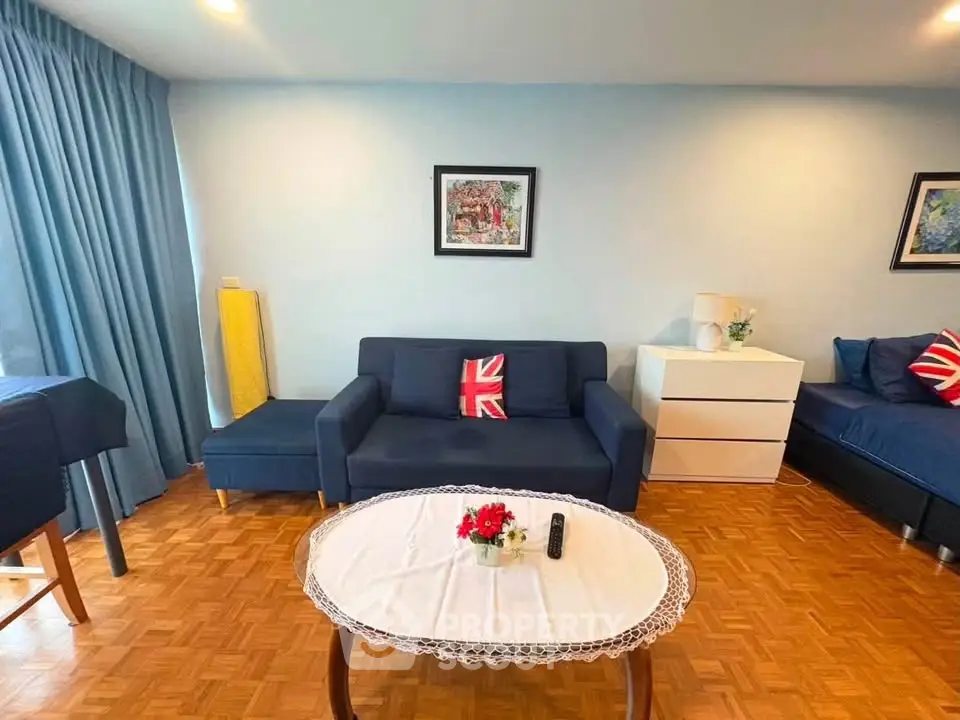 Charming living room with stylish decor and cozy seating area, perfect for relaxation and entertaining.