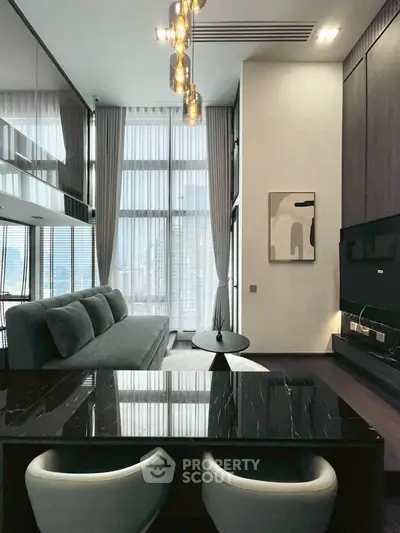 Luxurious modern living room with high ceilings and elegant decor in a high-rise apartment.