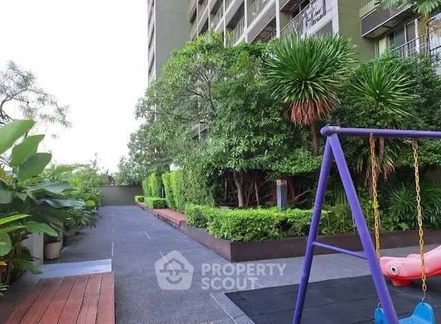 Lush garden area with playground in modern residential complex
