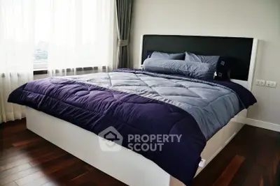 Modern bedroom with stylish bedding and large window view