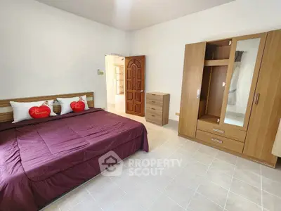 Spacious bedroom with modern wooden furniture and cozy bedding