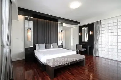 Luxurious modern bedroom with elegant decor and hardwood floors