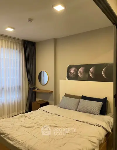 Cozy bedroom with modern decor and moon phase artwork above the bed.