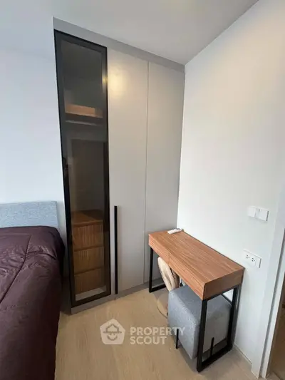 Modern bedroom with sleek wardrobe and stylish desk, perfect for urban living.