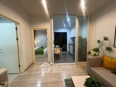 Modern apartment interior with cozy living room and open kitchen layout, featuring stylish decor and bright lighting.