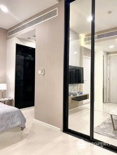 Modern bedroom with mirrored sliding doors and stylish decor