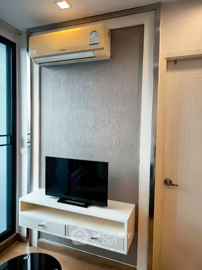 Modern living room with sleek TV stand and air conditioning unit