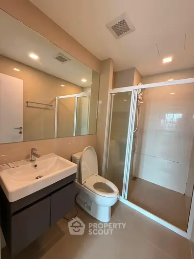 Modern bathroom with sleek fixtures and glass shower enclosure