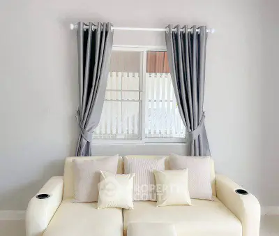 Elegant living room with cream sofa and stylish curtains