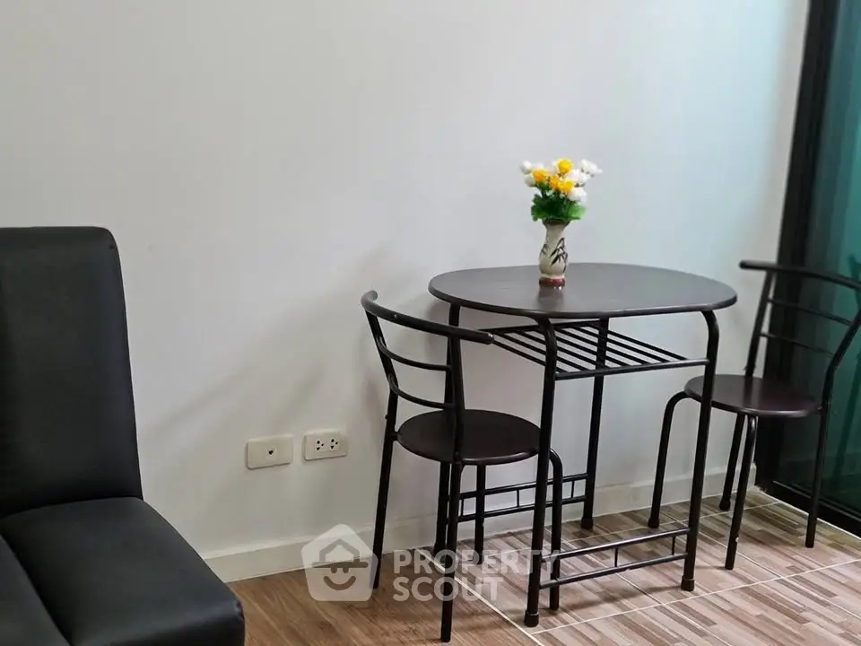 Cozy dining area with modern table and chairs, perfect for intimate meals in a stylish apartment.