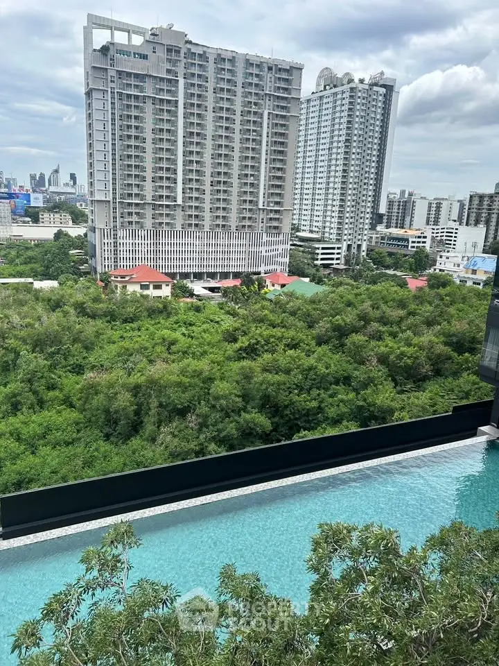 Stunning high-rise building view with lush greenery and a luxurious pool in the foreground.