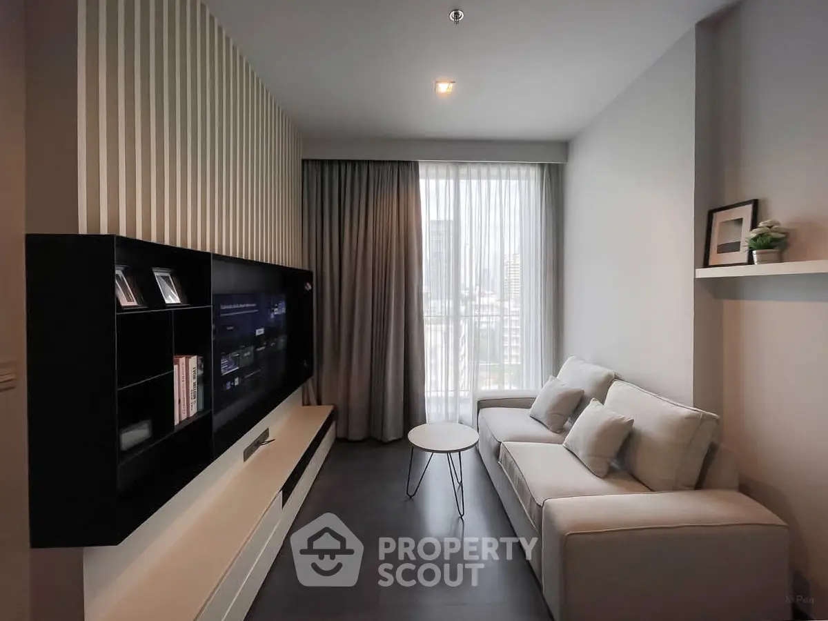 Modern living room with sleek design, featuring a wall-mounted TV, cozy sofa, and large window with city view.