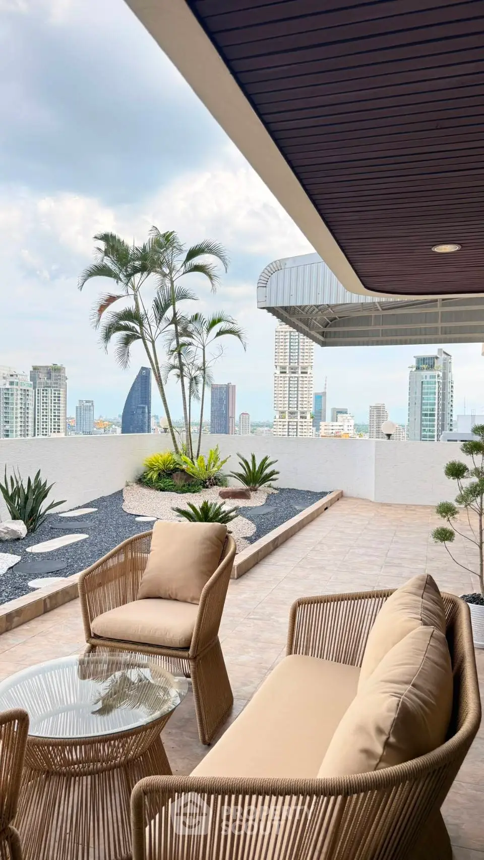 Luxurious rooftop terrace with stunning city skyline views and elegant outdoor seating.