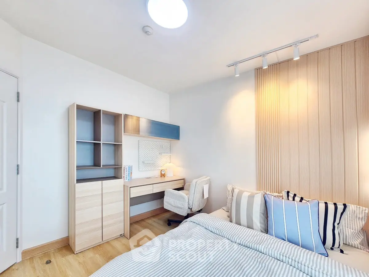 Modern bedroom with stylish decor and cozy ambiance, featuring a study desk and elegant lighting.